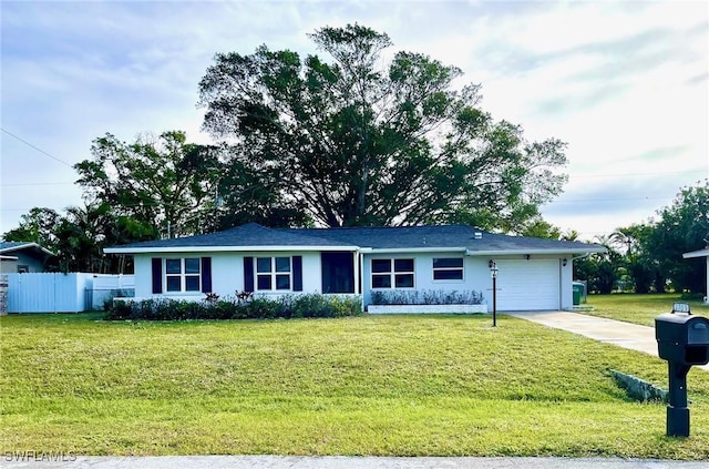 single story home featuring a garage and a front lawn