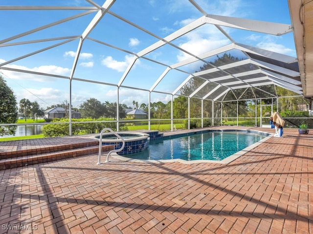 view of swimming pool with an in ground hot tub, a water view, glass enclosure, and a patio area