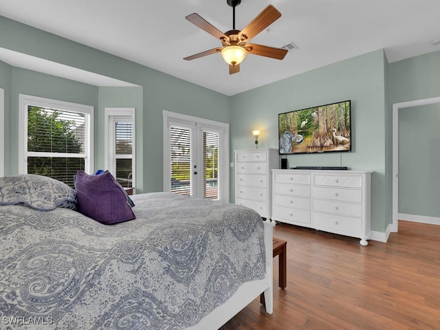 bedroom featuring access to exterior, dark hardwood / wood-style floors, and ceiling fan