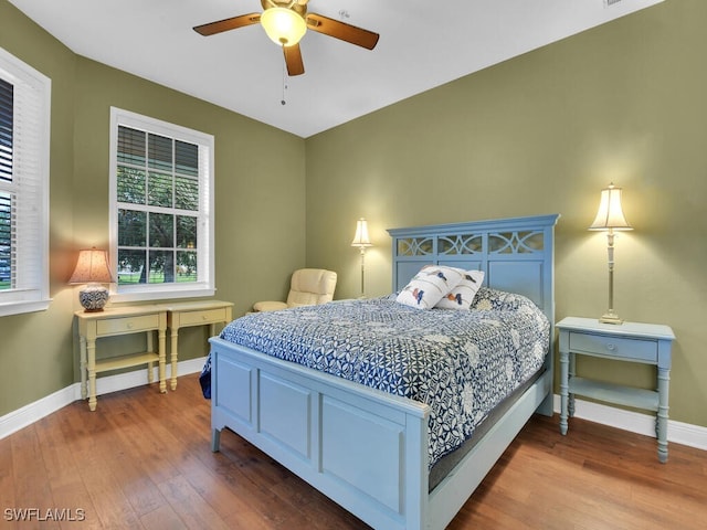 bedroom with ceiling fan and hardwood / wood-style floors