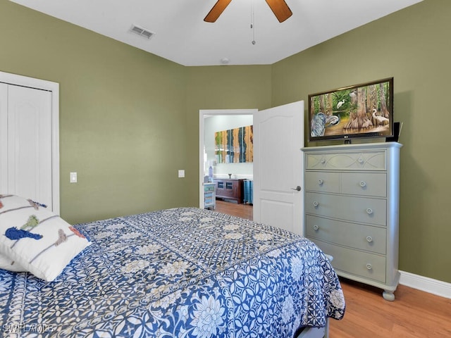 bedroom with light wood-type flooring, a closet, and ceiling fan