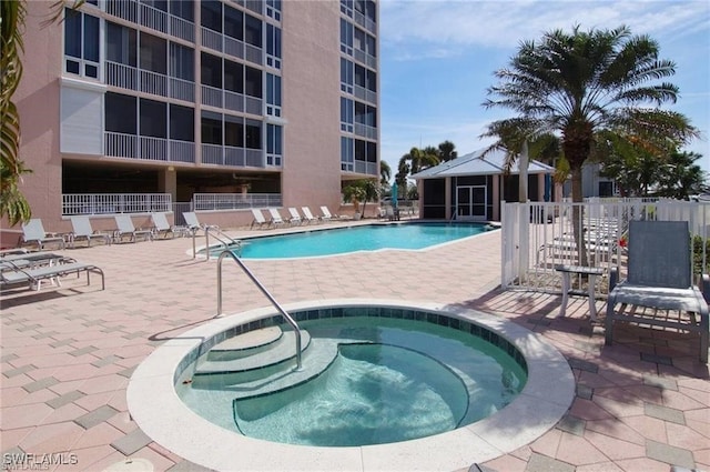 view of pool featuring a community hot tub, a patio, and a gazebo