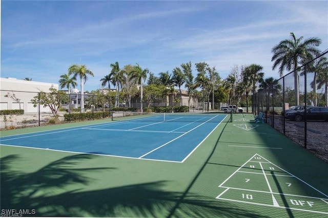 view of tennis court featuring basketball court