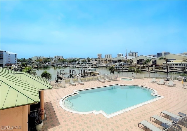 view of pool featuring a patio and a water view