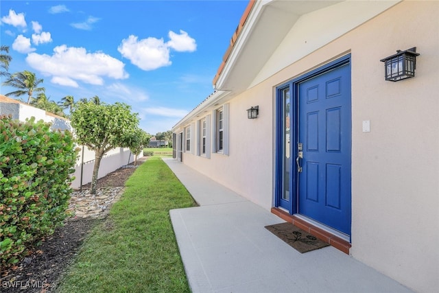 entrance to property with a yard