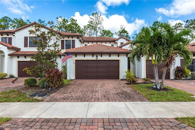 mediterranean / spanish-style house with a garage