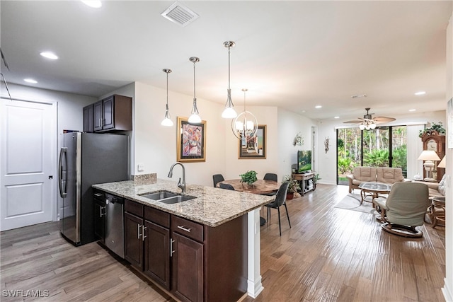 kitchen featuring light hardwood / wood-style floors, dark brown cabinets, sink, and appliances with stainless steel finishes