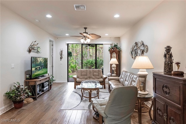 living room with hardwood / wood-style floors and ceiling fan