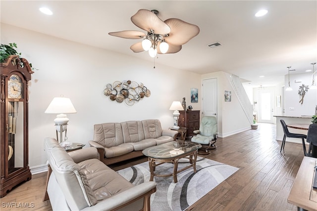 living room featuring hardwood / wood-style flooring and ceiling fan