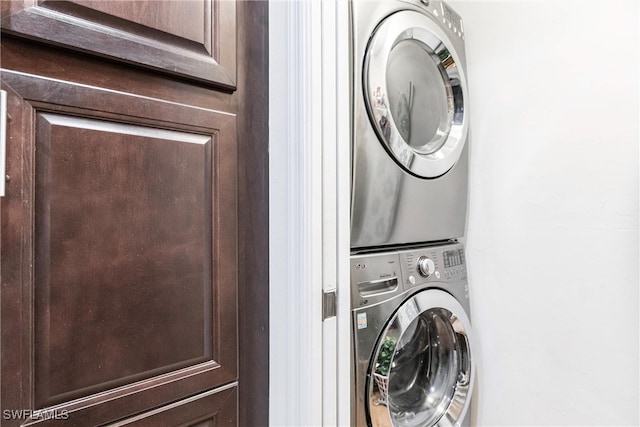 washroom featuring stacked washer and dryer