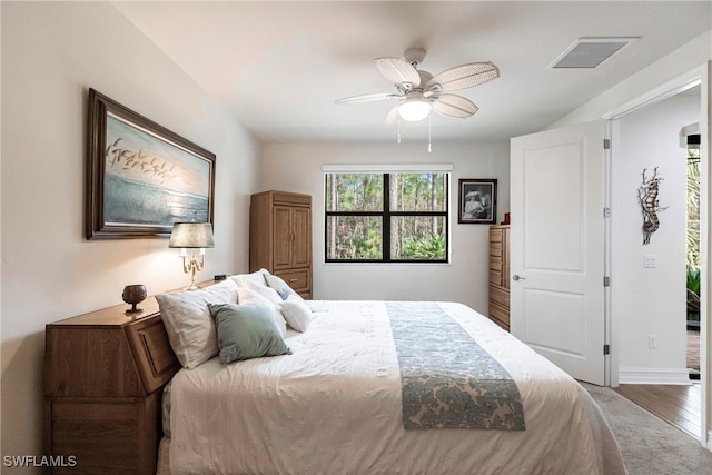 bedroom with hardwood / wood-style flooring and ceiling fan