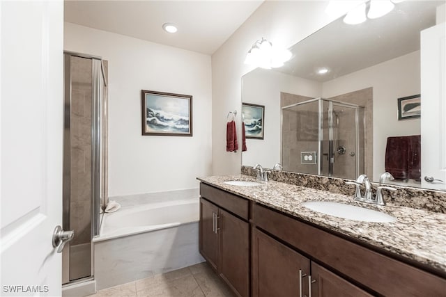 bathroom featuring tile patterned flooring, vanity, and separate shower and tub