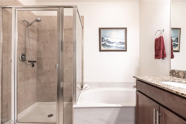 bathroom featuring independent shower and bath and vanity