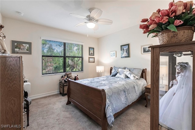 bedroom with ceiling fan and light colored carpet