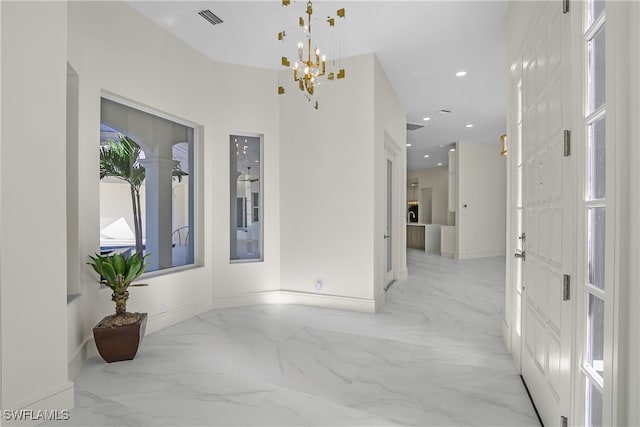 foyer entrance with baseboards, visible vents, marble finish floor, a chandelier, and recessed lighting