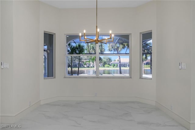 spare room with a chandelier and a water view