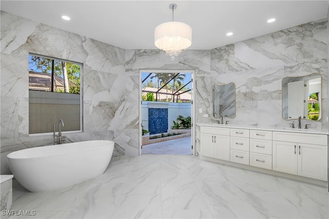 bathroom featuring vanity, a healthy amount of sunlight, and tile walls