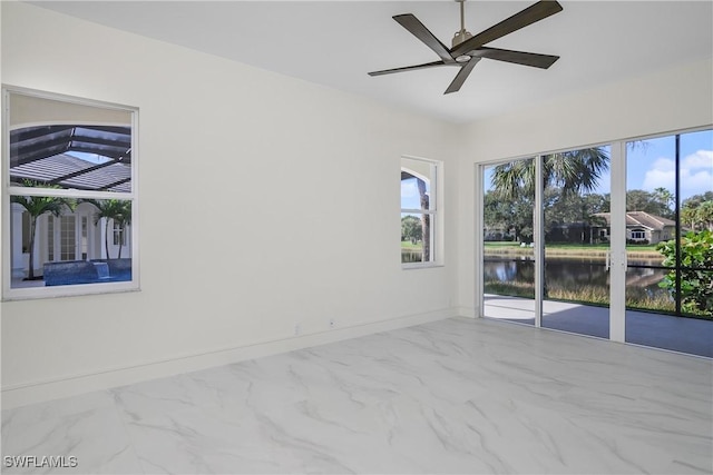 spare room featuring a water view and ceiling fan