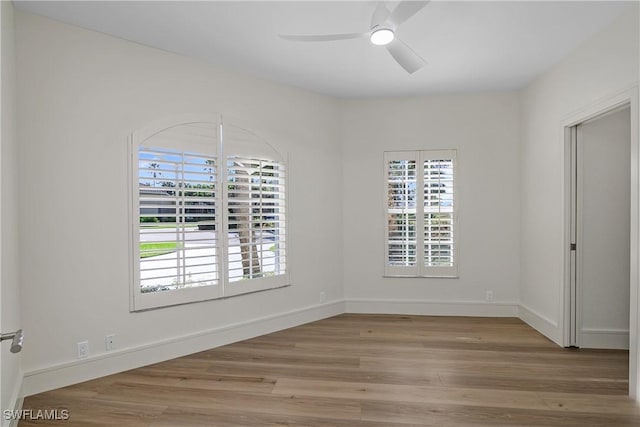 empty room featuring ceiling fan and light hardwood / wood-style flooring