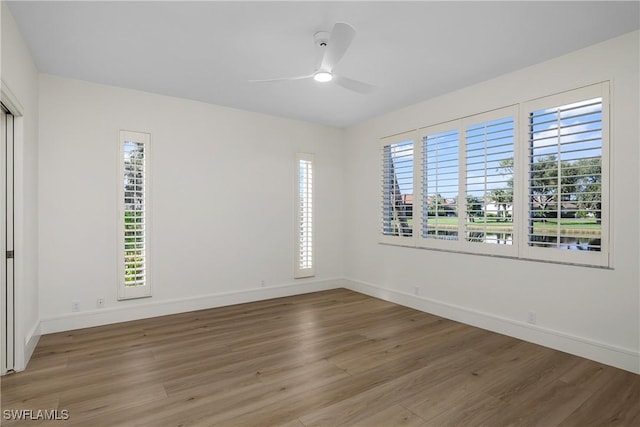 spare room with ceiling fan and wood-type flooring