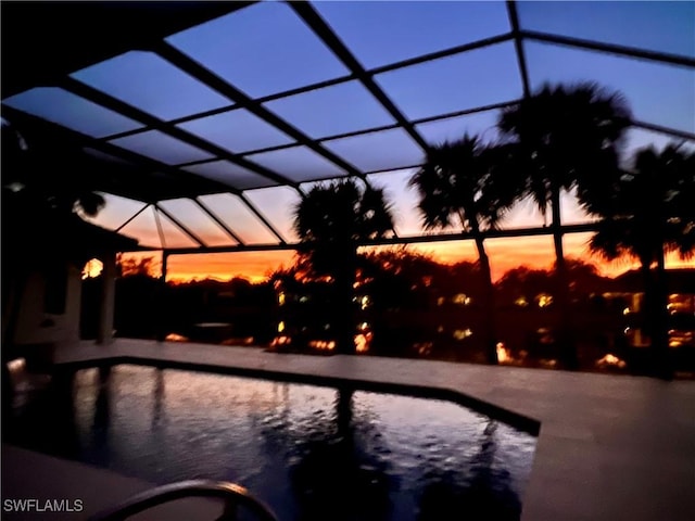 pool at dusk with glass enclosure