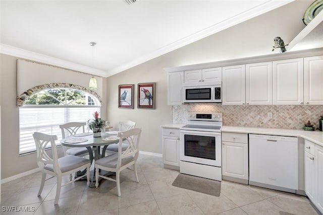 kitchen featuring lofted ceiling, white cabinets, pendant lighting, and white appliances