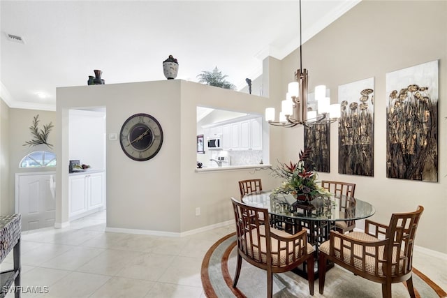 dining room with ornamental molding, a chandelier, light tile patterned flooring, and a towering ceiling