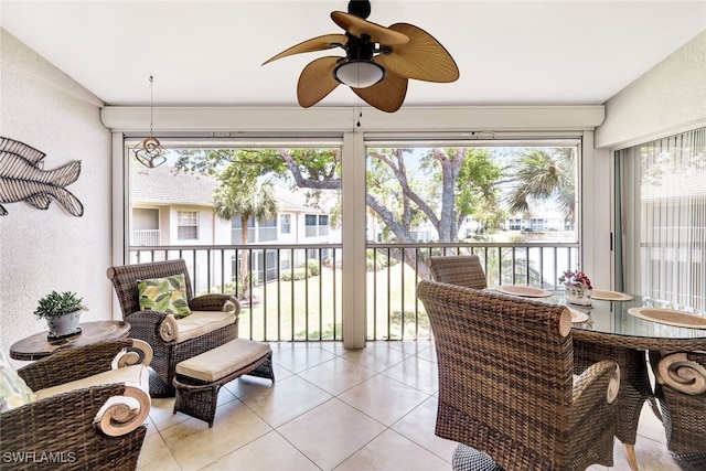 sunroom featuring vaulted ceiling and ceiling fan