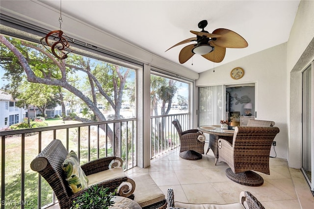 sunroom featuring vaulted ceiling and ceiling fan