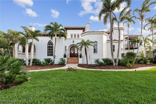 mediterranean / spanish house with a front yard