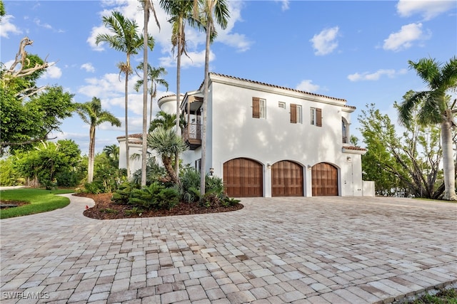 mediterranean / spanish-style house featuring a balcony and a garage