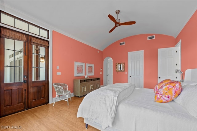 bedroom featuring ceiling fan, crown molding, vaulted ceiling, and light hardwood / wood-style flooring