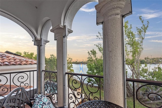 balcony at dusk with a water view