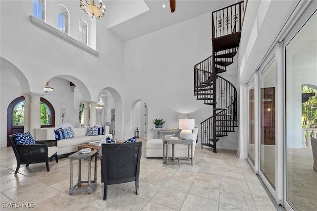 living room featuring an inviting chandelier and a high ceiling