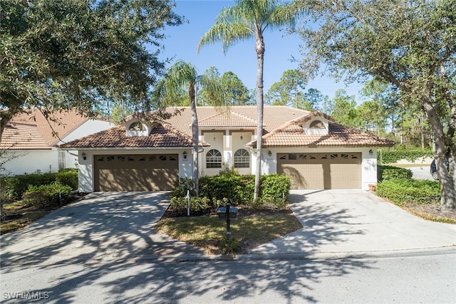 mediterranean / spanish-style house with a garage