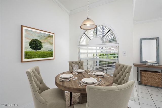 dining room with ornamental molding and light tile patterned flooring