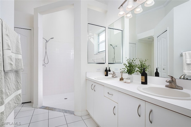 bathroom with vanity, tile patterned floors, and a tile shower