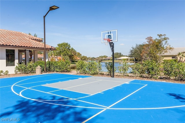 view of sport court featuring a water view