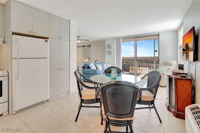 tiled dining area with ceiling fan