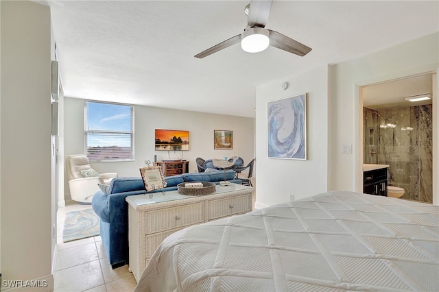 tiled bedroom featuring ensuite bath and ceiling fan