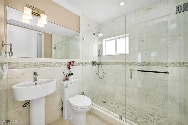 bathroom featuring a shower with shower door, tile walls, and toilet