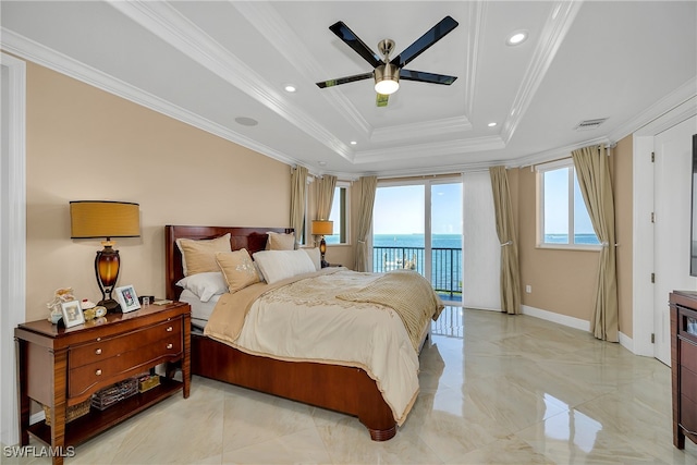 bedroom featuring a tray ceiling, ceiling fan, a water view, and ornamental molding