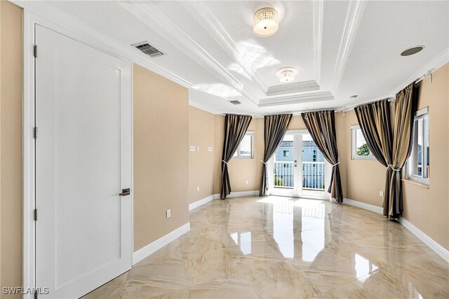 spare room featuring ornamental molding, a tray ceiling, and french doors