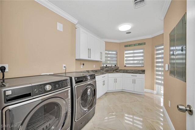 clothes washing area featuring sink, independent washer and dryer, and ornamental molding