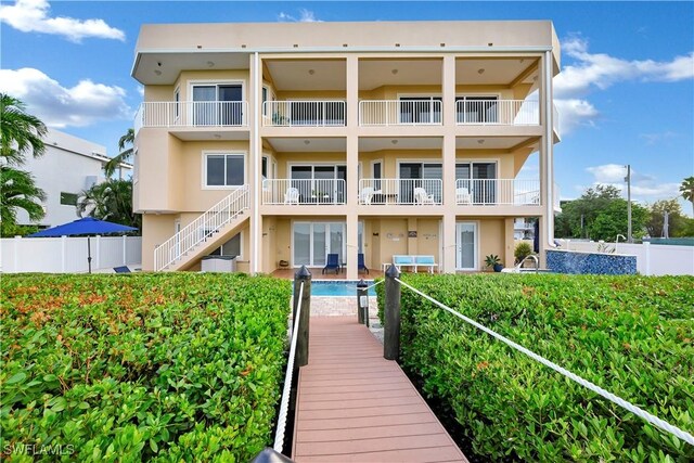 rear view of property with a fenced in pool