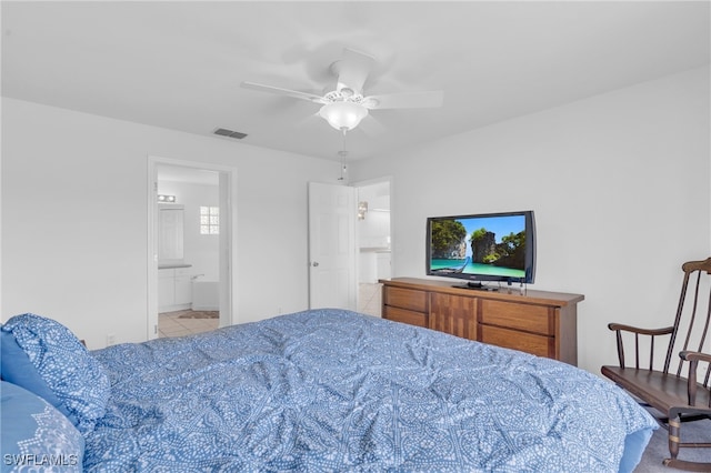 tiled bedroom featuring connected bathroom and ceiling fan