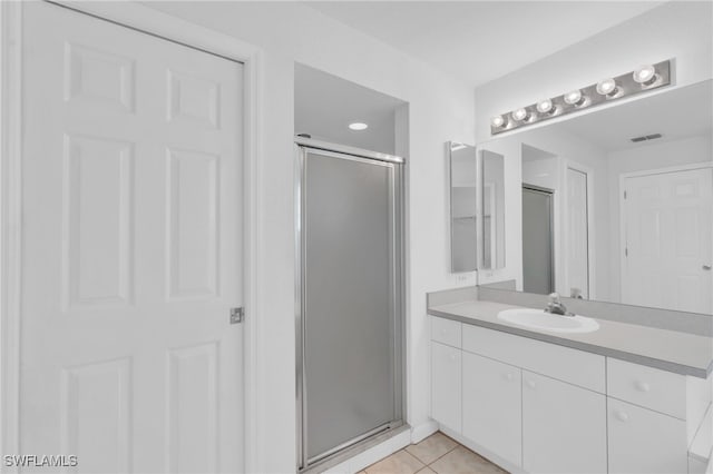 bathroom featuring vanity, tile patterned floors, and an enclosed shower