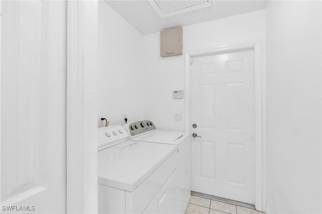 washroom with light tile patterned floors and washing machine and clothes dryer