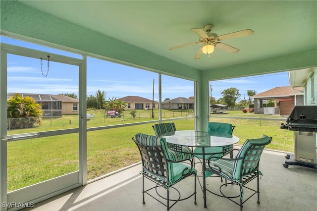 sunroom featuring ceiling fan