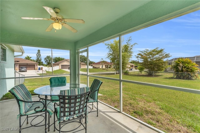 sunroom featuring ceiling fan